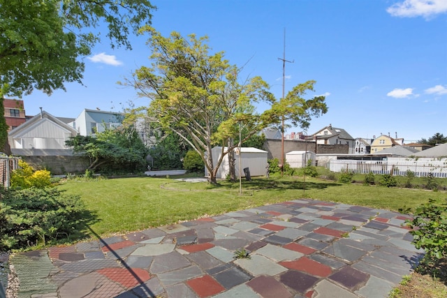 134 W 25th St, Bayonne, NJ 07002 - view of patio / terrace with a residential view, a storage unit, and an outbuilding