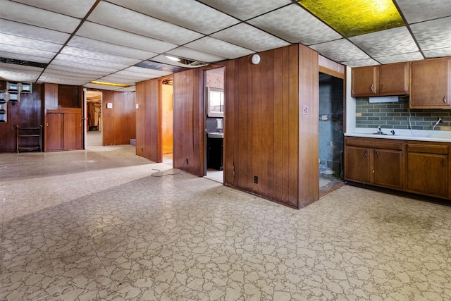 134 W 25th St, Bayonne, NJ 07002 - finished below grade area with a paneled ceiling, wood walls, and a sink