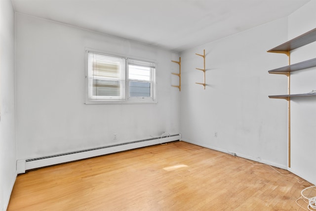 134 W 25th St, Bayonne, NJ 07002 - unfurnished room featuring a baseboard heating unit and wood finished floors