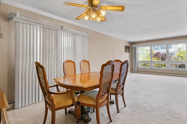 134 W 25th St, Bayonne, NJ 07002 - dining area featuring light carpet, a ceiling fan, and a baseboard radiator