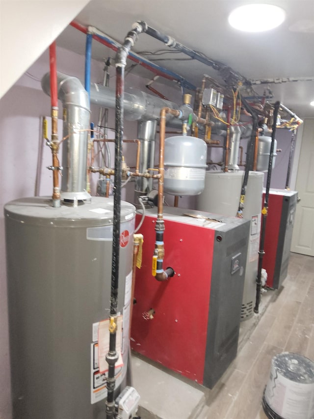 utility room featuring water heater and gas water heater