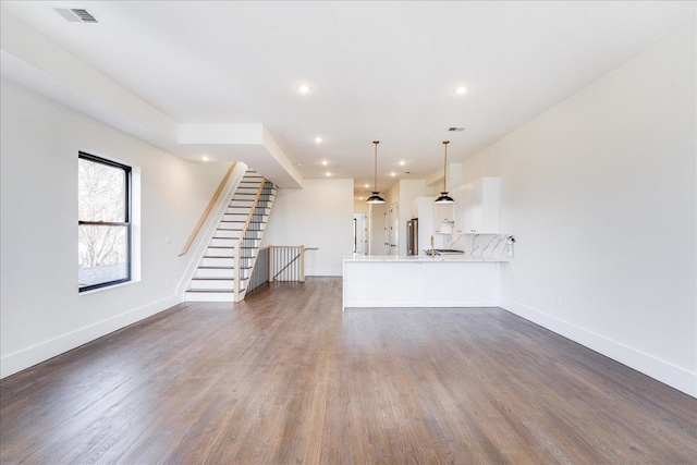 unfurnished living room with dark hardwood / wood-style floors