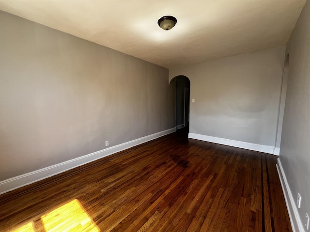 901 Grand Ave Unit B5, North Bergen, NJ 07047 - empty room with arched walkways, dark wood-type flooring, and baseboards