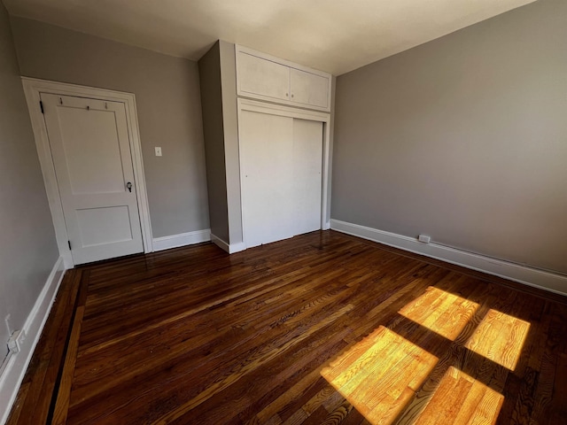 901 Grand Ave Unit B5, North Bergen, NJ 07047 - unfurnished bedroom featuring a closet, dark wood finished floors, and baseboards