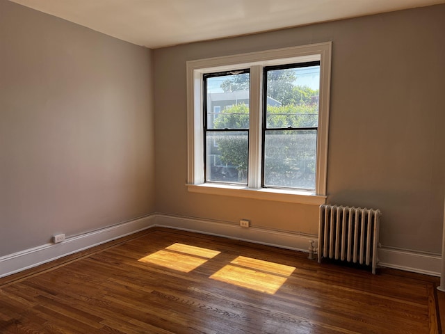 901 Grand Ave Unit B5, North Bergen, NJ 07047 - empty room featuring radiator heating unit, dark wood-type flooring, and baseboards