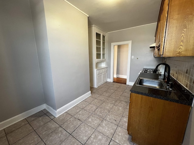 901 Grand Ave Unit B5, North Bergen, NJ 07047 - kitchen with a sink, light tile patterned floors, dark countertops, tasteful backsplash, and baseboards