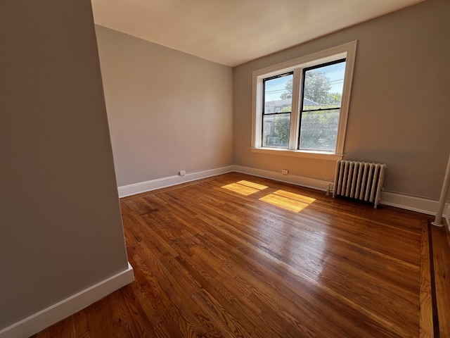 901 Grand Ave Unit B5, North Bergen, NJ 07047 - unfurnished room with radiator heating unit, baseboards, and dark wood-style flooring