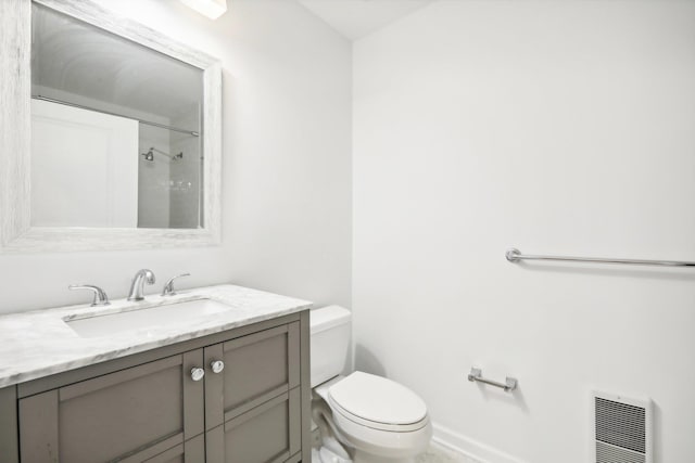 bathroom featuring baseboards, a shower, toilet, heating unit, and vanity