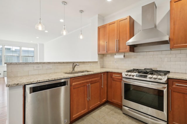 kitchen featuring stainless steel appliances, a peninsula, a sink, wall chimney exhaust hood, and tasteful backsplash