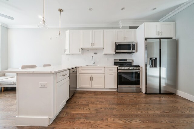 kitchen with white cabinets, kitchen peninsula, stainless steel appliances, and dark hardwood / wood-style flooring