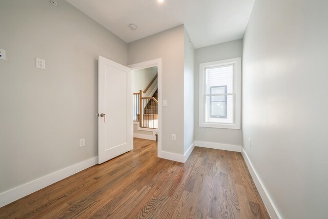 unfurnished bedroom with hardwood / wood-style flooring