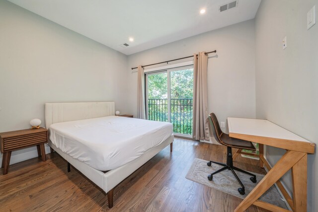 bedroom featuring access to exterior and dark hardwood / wood-style flooring