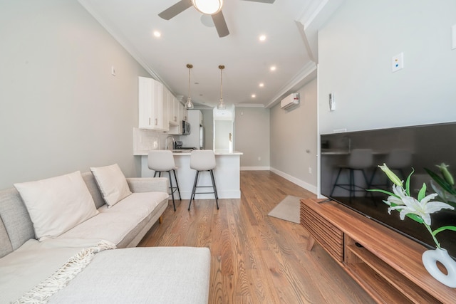 living room with ceiling fan, light hardwood / wood-style flooring, and ornamental molding