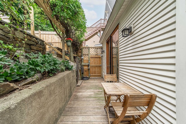 wooden terrace featuring a gate and fence