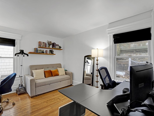 office area with baseboards and wood finished floors