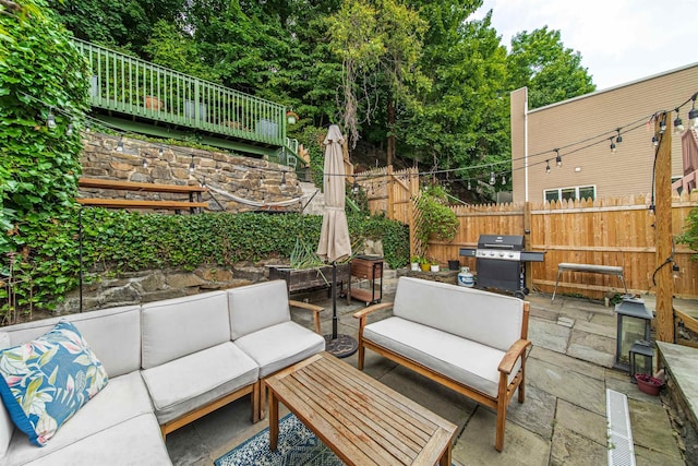 view of patio with an outdoor hangout area, area for grilling, and fence