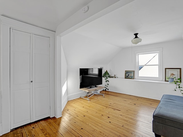 living area with lofted ceiling and wood finished floors