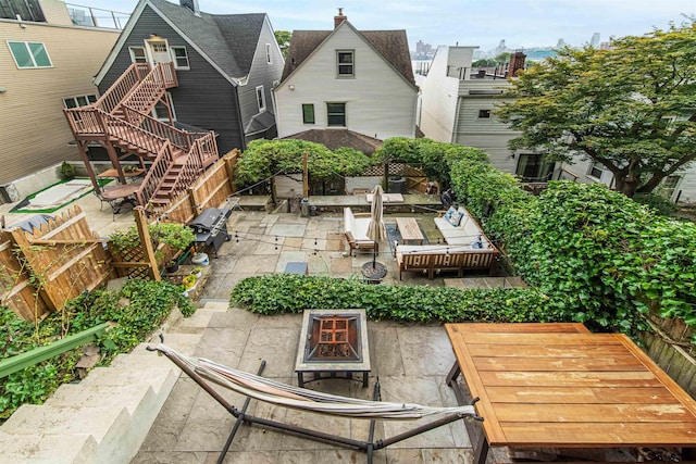 rear view of house featuring an outdoor fire pit, stairs, a residential view, and a patio