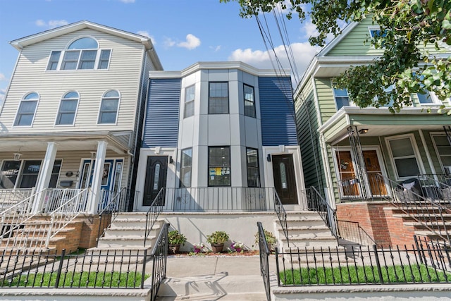 133 W 4th St, Bayonne, NJ 07002 - townhome / multi-family property featuring covered porch, a fenced front yard, a gate, and stairway