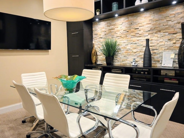 dining room with carpet floors and baseboards