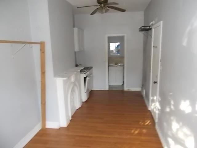 hall with wood-type flooring and washer / clothes dryer