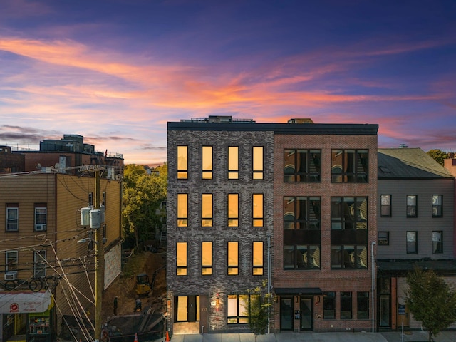 view of outdoor building at dusk