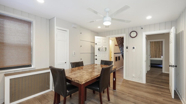 dining space featuring radiator heating unit, hardwood / wood-style floors, and ceiling fan