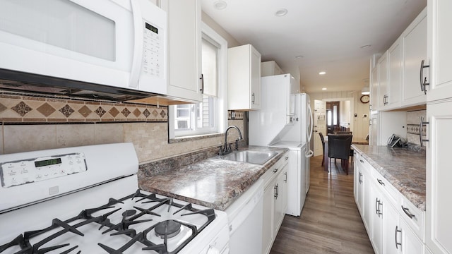 kitchen featuring dark hardwood / wood-style flooring, white cabinets, sink, backsplash, and white appliances