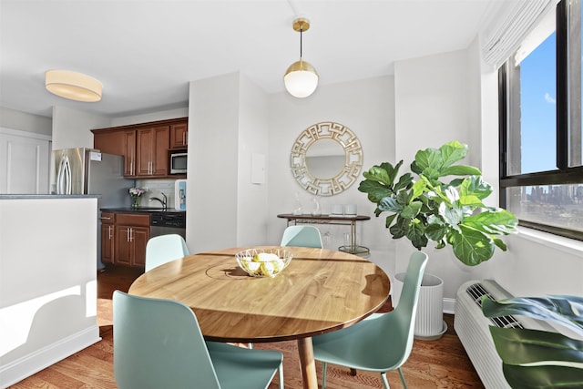 dining room with wood finished floors and baseboards