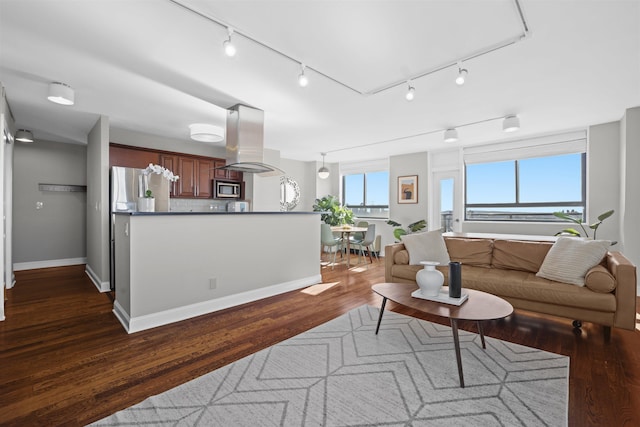 living area featuring dark wood-type flooring and baseboards