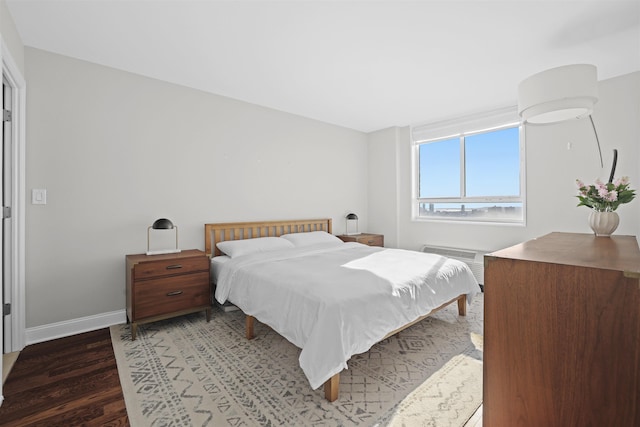 bedroom featuring wood finished floors and baseboards