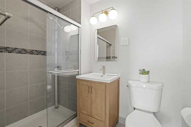 full bath with a stall shower, vanity, and toilet