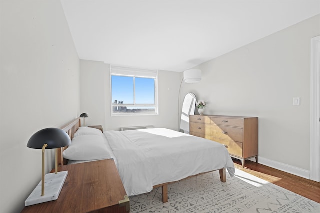 bedroom featuring baseboards and wood finished floors