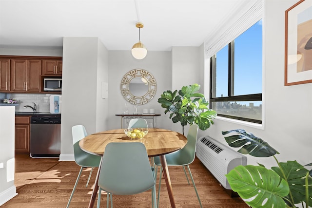 dining room featuring baseboards and dark wood-type flooring