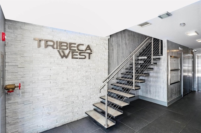staircase with tile patterned floors, visible vents, and elevator