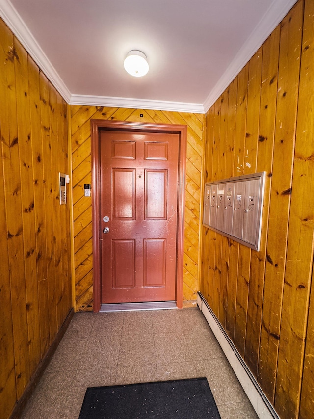 doorway to outside with mail boxes, crown molding, wooden walls, and a baseboard heating unit