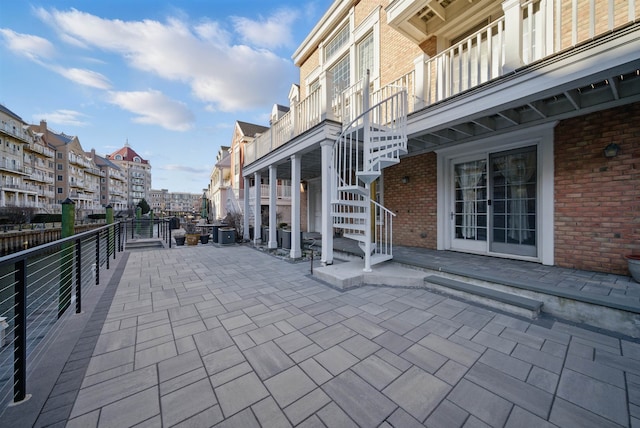 view of home's community with stairs and a patio