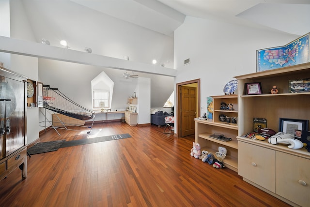 interior space with visible vents, high vaulted ceiling, and wood finished floors