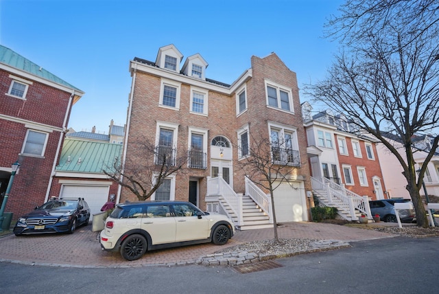 multi unit property with brick siding and an attached garage