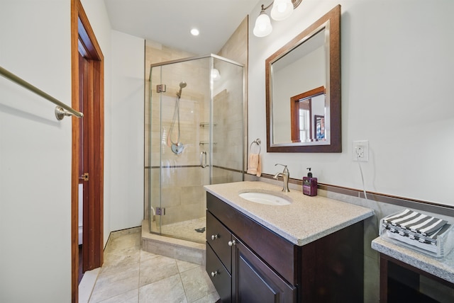 bathroom featuring vanity, a shower stall, and tile patterned flooring