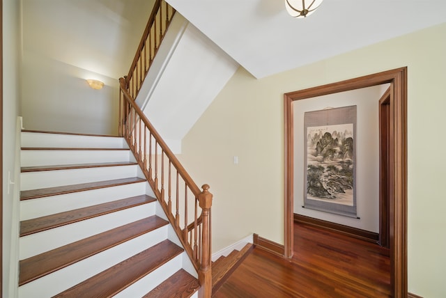 stairs featuring baseboards and wood finished floors