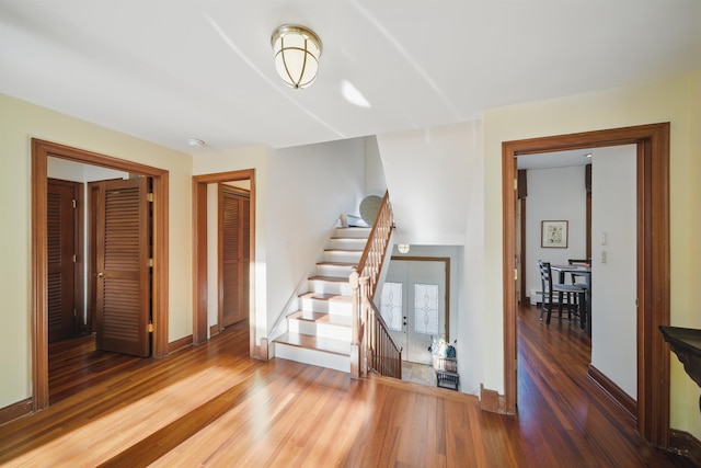 interior space featuring wood finished floors, baseboards, and french doors