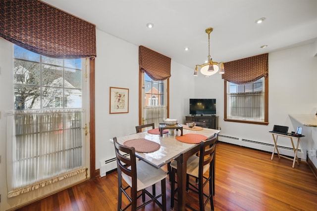 dining area featuring recessed lighting, a baseboard radiator, and wood finished floors