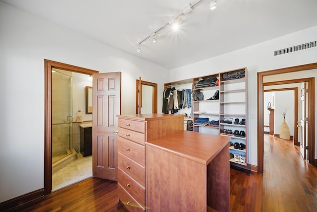 walk in closet featuring dark wood-style floors and visible vents