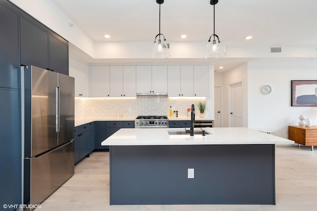 425 3rd St Unit 404, Jersey City, NJ 07302 - kitchen featuring appliances with stainless steel finishes, light countertops, decorative backsplash, hanging light fixtures, and recessed lighting