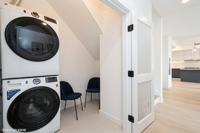 425 3rd St Unit 404, Jersey City, NJ 07302 - washroom with stacked washer / dryer and light wood-type flooring