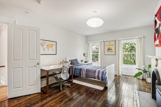 bedroom with dark hardwood / wood-style floors