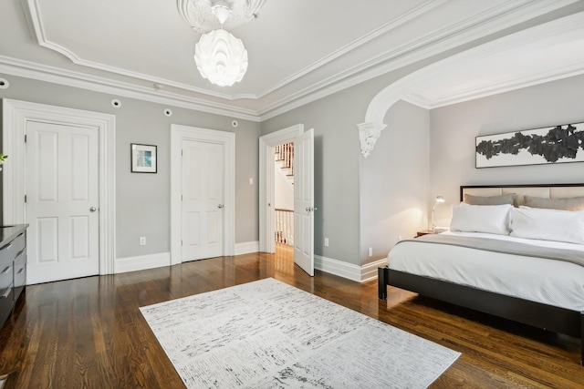 bedroom with dark wood-type flooring and crown molding