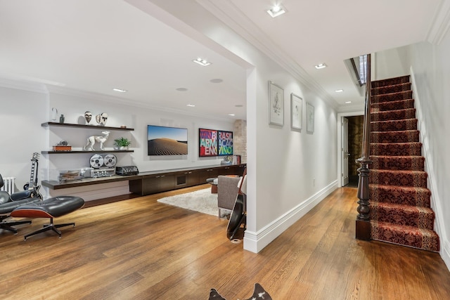 interior space with hardwood / wood-style floors and crown molding