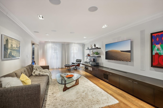 living room featuring light wood-type flooring and crown molding